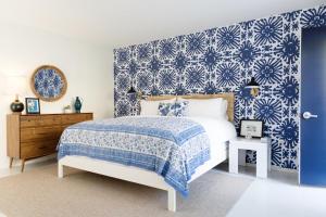 棕榈泉棕榈泉假日之家酒店的卧室设有蓝白色图案的墙壁