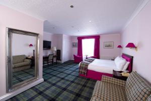珀斯皇家乔治酒店的酒店客房,配有床和镜子
