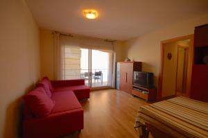 滨海托萨Lets Holidays Apartment Vinya del Pla的客厅配有红色沙发和电视