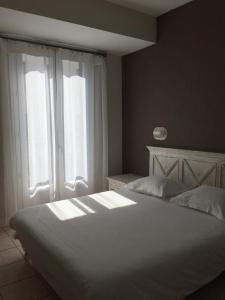 巴斯蒂亚波拿巴特酒店的卧室配有白色的床和窗户。