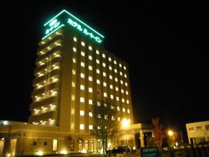 关町鲁特酒店-塞科旅馆的一座建筑物,上面有夜间标志