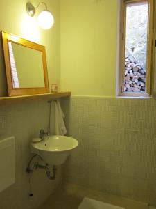 马来济格Flori Adriatic的一间带水槽和镜子的浴室以及窗户。