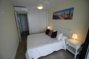 坎佩略Bellavista apartment的一间小卧室,配有白色的床和枕头