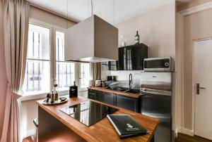 波尔多YBH大教堂公寓的厨房配有不锈钢冰箱和台面