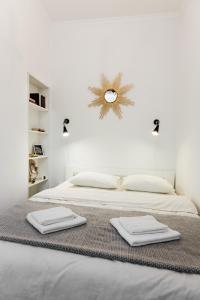 利沃夫Sweet Home Apartment的白色卧室配有两张带毛巾的床