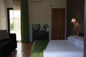 皮耶迪蒙泰埃特内奥故事餐厅及套房度假酒店的一间卧室配有一张床、一台电视和一个窗口