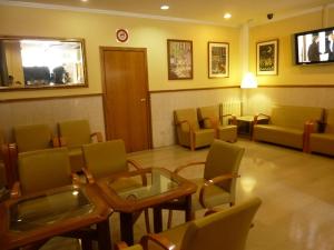 巴塞罗那罗马雷阿尔酒店的一间设有椅子和玻璃桌及椅子的等候室
