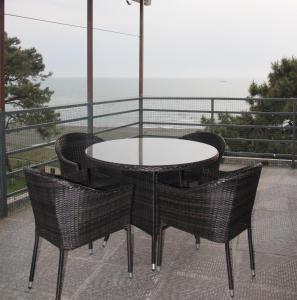 乌雷基Apartment near the Black Sea Ureki的阳台配有桌椅