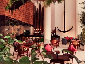 胡志明市东桂神秘岛酒店的一间带桌椅和吊灯的餐厅
