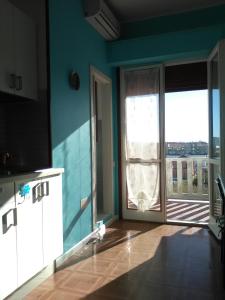 马洛塔Donatella Mini Apartment的厨房设有大玻璃门和阳台