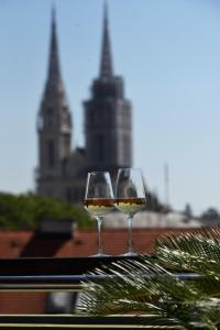 萨格勒布Zagreb Rooftops的桌子上坐着两杯白葡萄酒