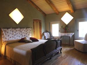 比耶拉Guest house Cascina Belsito的一间卧室设有一张大床和两个窗户。