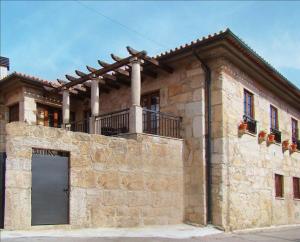 RoutarCasa de Campo Patio do Avo的一座石头建筑,上面设有一个阳台