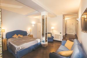 贝加莫瓦莱塔勒莱斯酒店的一间卧室配有一张床和一个沙发