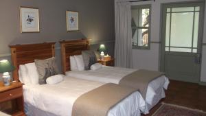 De RustHouseMartin Lodge & Self Catering的一间卧室设有两张大床和一扇窗户