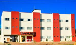 Novo ProgressoTapajos Palace Hotel的一座红色和白色的建筑,上面有标志