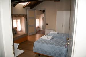 福萨诺Palazzo Sacco Hostello Fossano的一间小房间,配有两张床和一张沙发