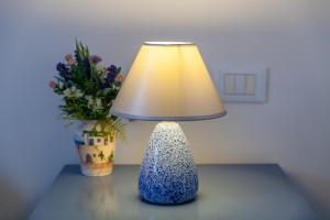 莫诺波利Villa Carenza的花瓶旁边的桌子上的灯