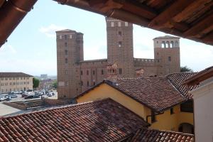 福萨诺Palazzo Sacco Hostello Fossano的从两座塔楼建筑的屋顶上欣赏美景
