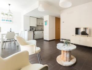 马德里马德里拉加塔公寓的客厅配有白色家具和桌子