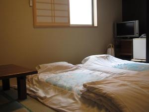 东京富士旅馆的电视间内的一张未铺床