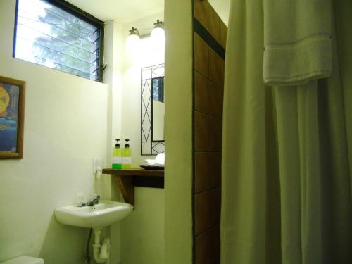 蓬塔戈尔达Creekside Oasis的一间带水槽和卫生间的浴室以及窗户。