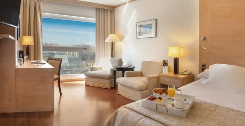 瓦伦西亚SH瓦伦西亚宫酒店的酒店客房设有一间带一张床和一张书桌的卧室