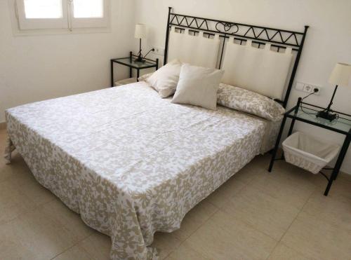 马尔格莱特德玛Apartamento Felicidad的一间卧室配有一张带2个床头柜的大床