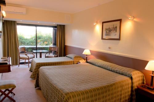 Termas de Salto Grande奥拉希奥基罗加酒店的酒店客房设有两张床和窗户。