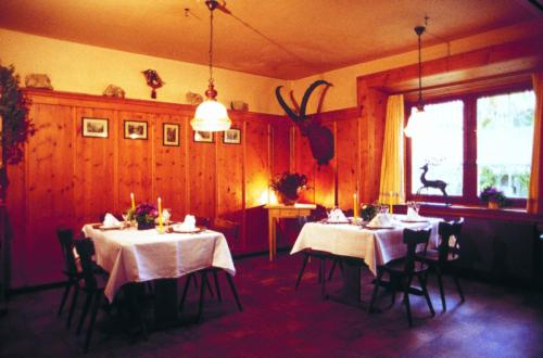 齐利斯阿特普斯特酒店的一间用餐室,配有2张带白色桌布的桌子