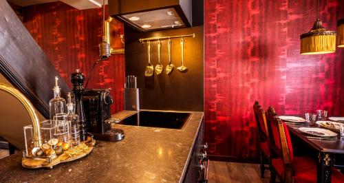 马斯特里赫特Maison Au Cheval Noir的一个带柜台和红色墙壁的厨房