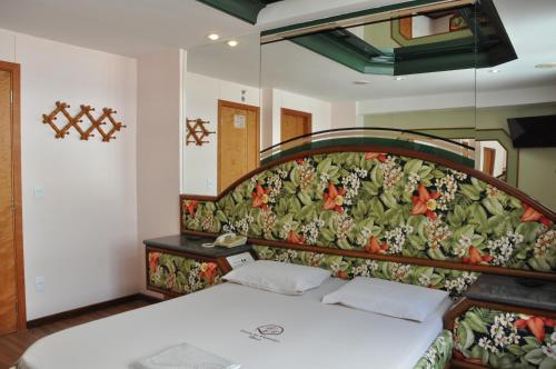 里约热内卢巴朗多弗拉门戈酒店（仅接待成人）的一间卧室配有一张带花卉床头板的床
