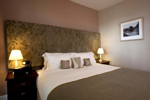 查格福德三皇冠酒店的一间卧室配有一张大床和两个枕头