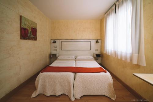 潘普洛纳卡斯蒂略哈维尔酒店的一间带两张床的卧室,位于带窗户的房间内