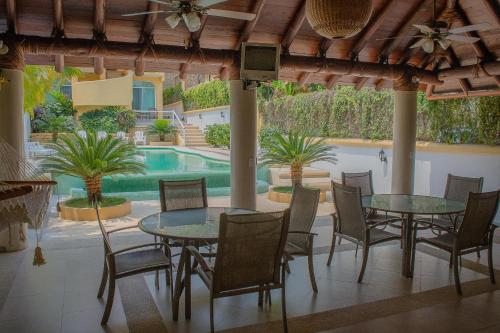 锡瓦塔塔内霍Bungalows Arena Dorada的一个带桌椅的庭院和一个游泳池