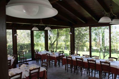 卡拉马尼科泰尔梅洛坎达巴罗酒店的用餐室设有桌椅和窗户。