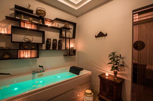 暹粒曼恩精品Spa酒店的浴室配有蓝色灯光的大浴缸