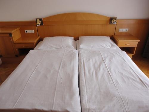 圣卡尼兹弗瑞恩瓦豪昂罗盖特斯酒店的一张带两个枕头和两个床头柜的床