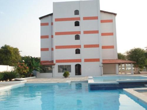 萨利纳斯-达马加里达Salinas Praia Hotel的建筑前的一座带游泳池的建筑