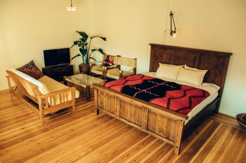 北谷町奥尔斯酒店的一间卧室配有一张床、一把椅子和一张沙发