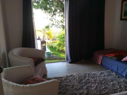 普纳奥亚Bungalow Premium Tahiti的客厅配有两把椅子和窗户