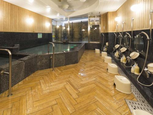 高知米娜托娅酒店的大型浴室设有游泳池和卫生间
