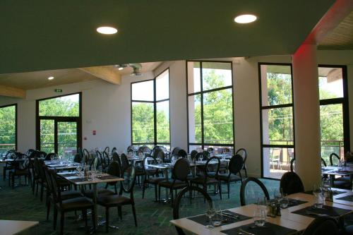 圣若里奥勒普雷杜拉克酒店的用餐室设有桌椅和窗户。