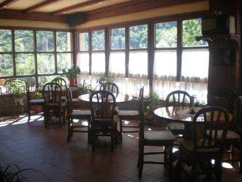 托尔拉Hotel Bellavista Ordesa的用餐室设有桌椅和窗户。