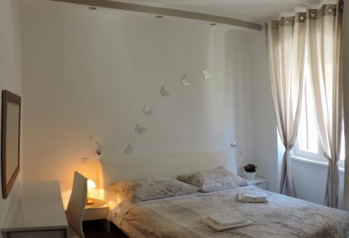 希贝尼克Apartment & room Ivan的一间卧室配有一张床、一张书桌和一个窗户。