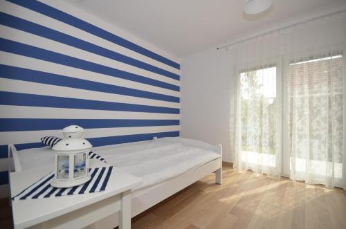 达洛科Apartamenty Mariner的一间卧室配有一张蓝色和白色条纹的床