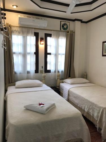 琅勃拉邦坎空美景旅馆的带两张床和两个窗户的房间