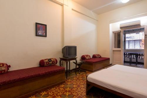 孟买戈拉巴住宿加早餐旅馆的一间酒店客房,设有两张床和电视
