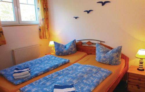 青斯特Ferienwohnung Strandmuschel的卧室设有两张单人床,配有蓝色床单