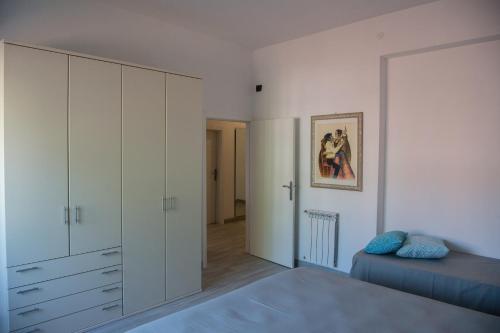 格罗塞托港Wonderful house in Marina di Grosseto的卧室配有白色橱柜和1张床。